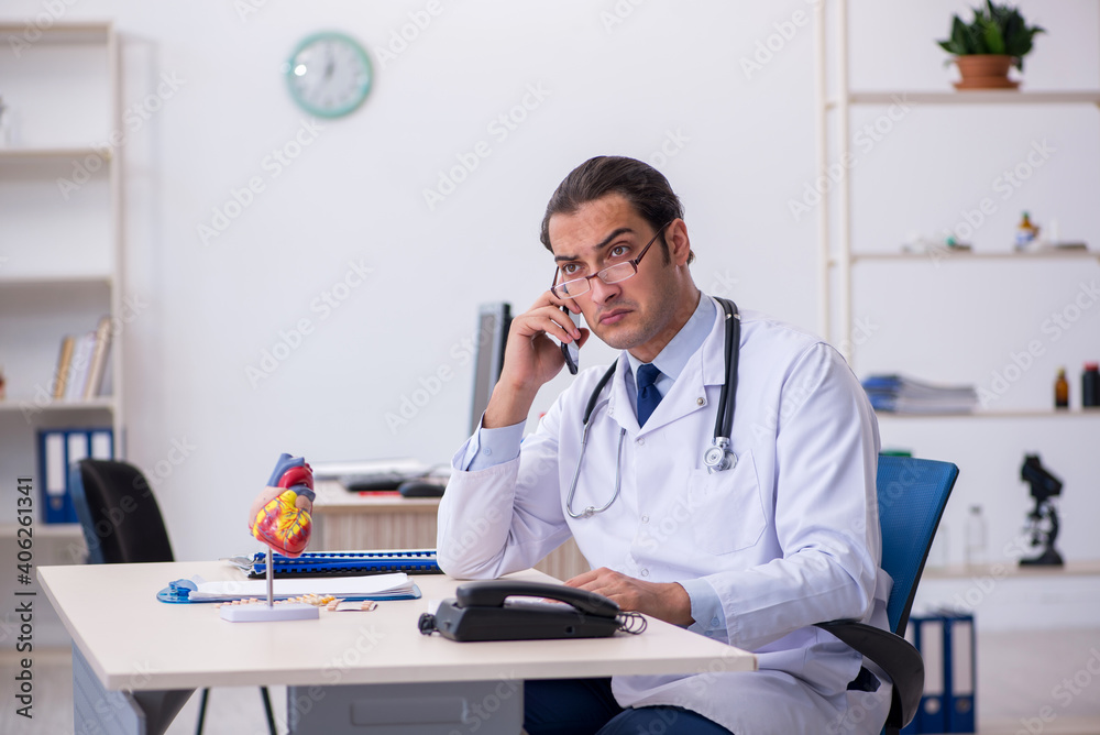 Young male doctor cardiologist working in the clinic Young male doctor cardiologist working in the clinic