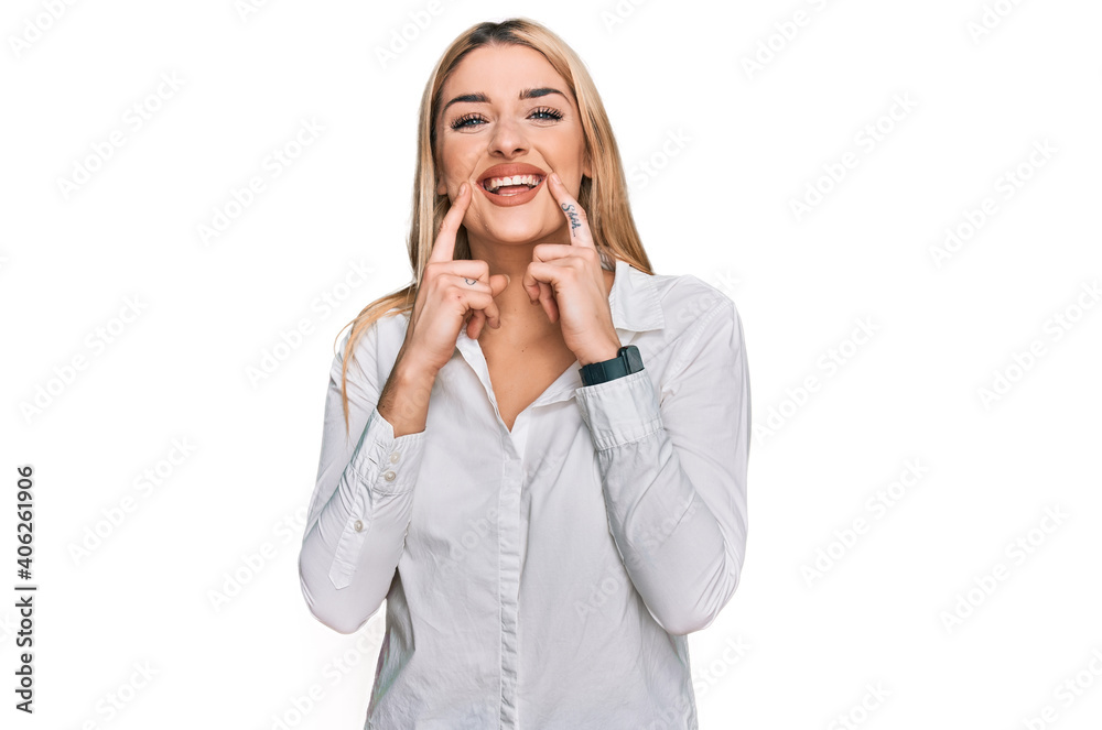 Young caucasian woman wearing casual clothes smiling with open mouth, fingers pointing and forcing cheerful smile Young caucasian woman wearing casual clothes smiling with open mouth, fingers pointing and forcing cheerful smile