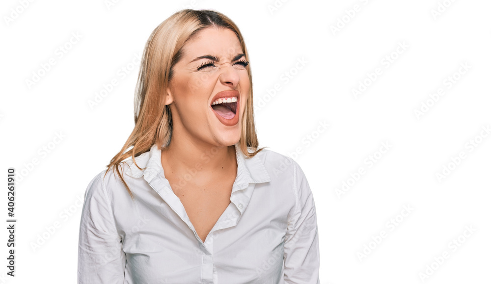 Young caucasian woman wearing casual clothes angry and mad screaming frustrated and furious, shouting with anger. rage and aggressive concept. Young caucasian woman wearing casual clothes angry and mad screaming frustrated and furious, shouting with anger. rage and aggressive concept.
