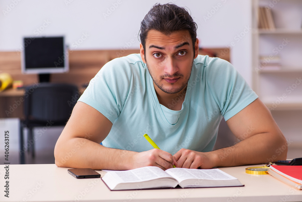 Young male student preparing for exam at home Young male student preparing for exam at home