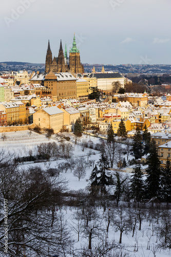 Snowy Prague City with gothic Castle from Hill Petrin in the sunny Day, Czech republic