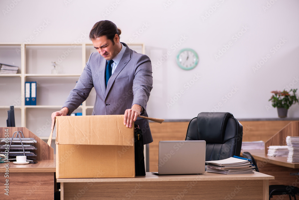 Young male employee being dismissed from his work Young male employee being dismissed from his work
