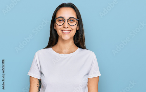 Young hispanic woman wearing casual white t shirt with a happy and cool smile on face. lucky person. © Krakenimages.com