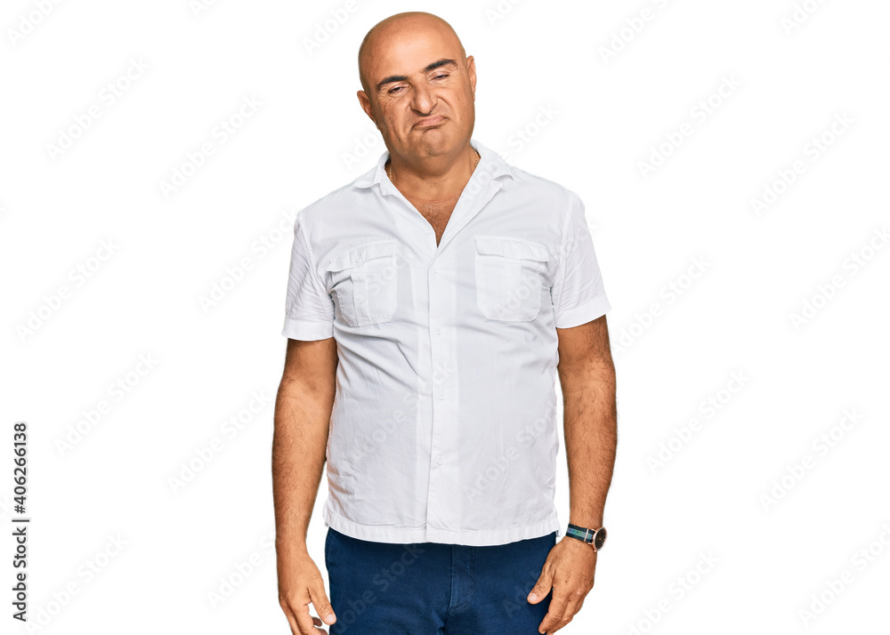 Fototapeta premium Mature middle east man with mustache wearing casual white shirt looking sleepy and tired, exhausted for fatigue and hangover, lazy eyes in the morning.