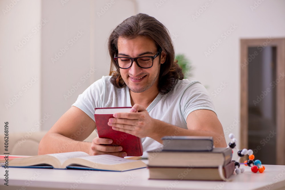Young male student preparing for exams at home Young male student preparing for exams at home