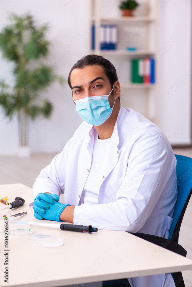 Young male chemist working in the lab during pandemic Young male chemist working in the lab during pandemic