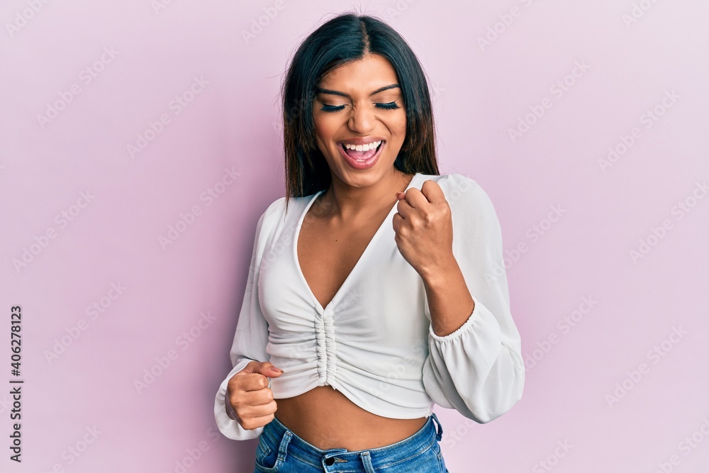 Young latin transsexual transgender woman wearing casual clothes celebrating surprised and amazed for success with arms raised and eyes closed Young latin transsexual transgender woman wearing casual clothes celebrating surprised and amazed for success with arms raised and eyes closed