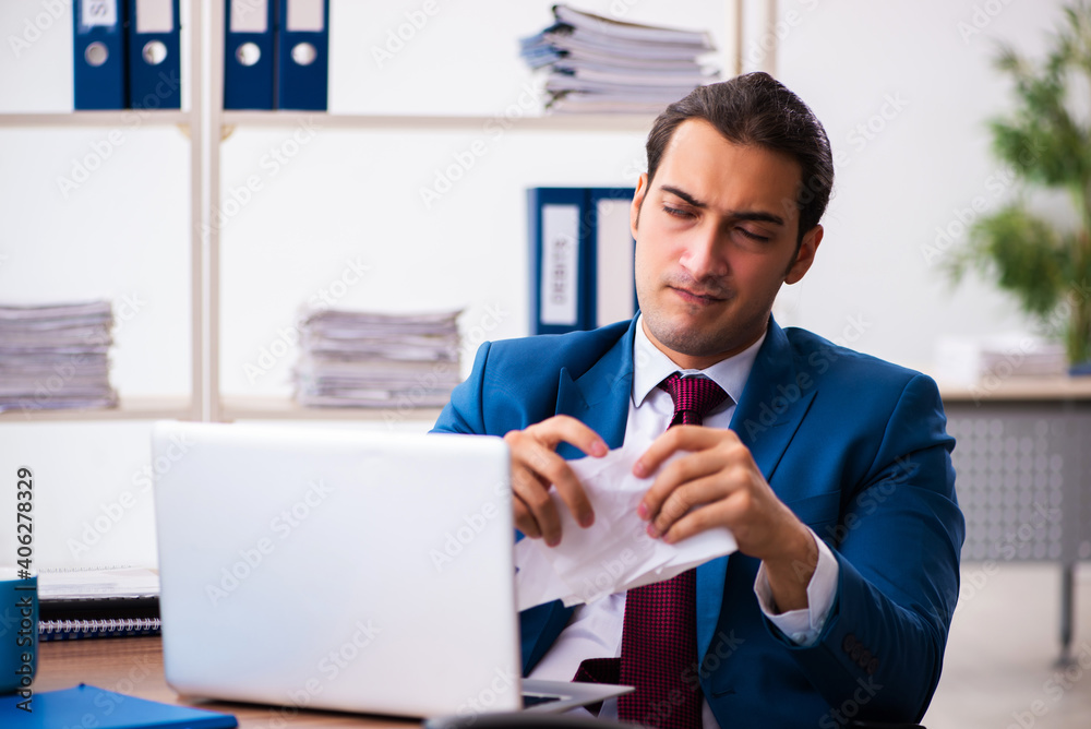 Young male employee working in the office Young male employee working in the office