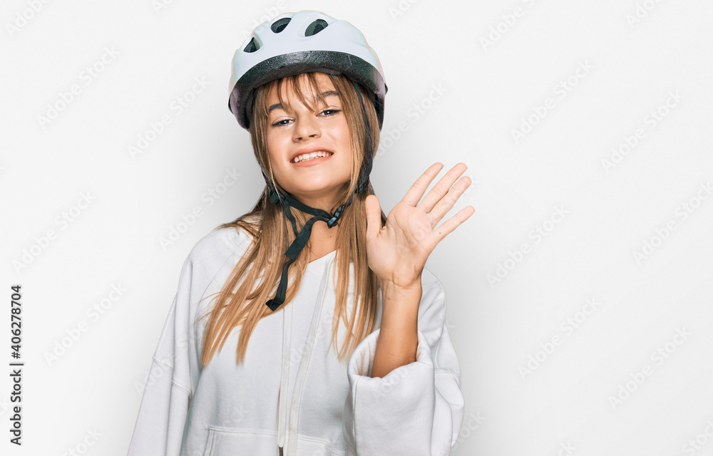 Teenager caucasian girl wearing bike helmet showing and pointing up with fingers number five while smiling confident and happy. Teenager caucasian girl wearing bike helmet showing and pointing up with fingers number five while smiling confident and happy.