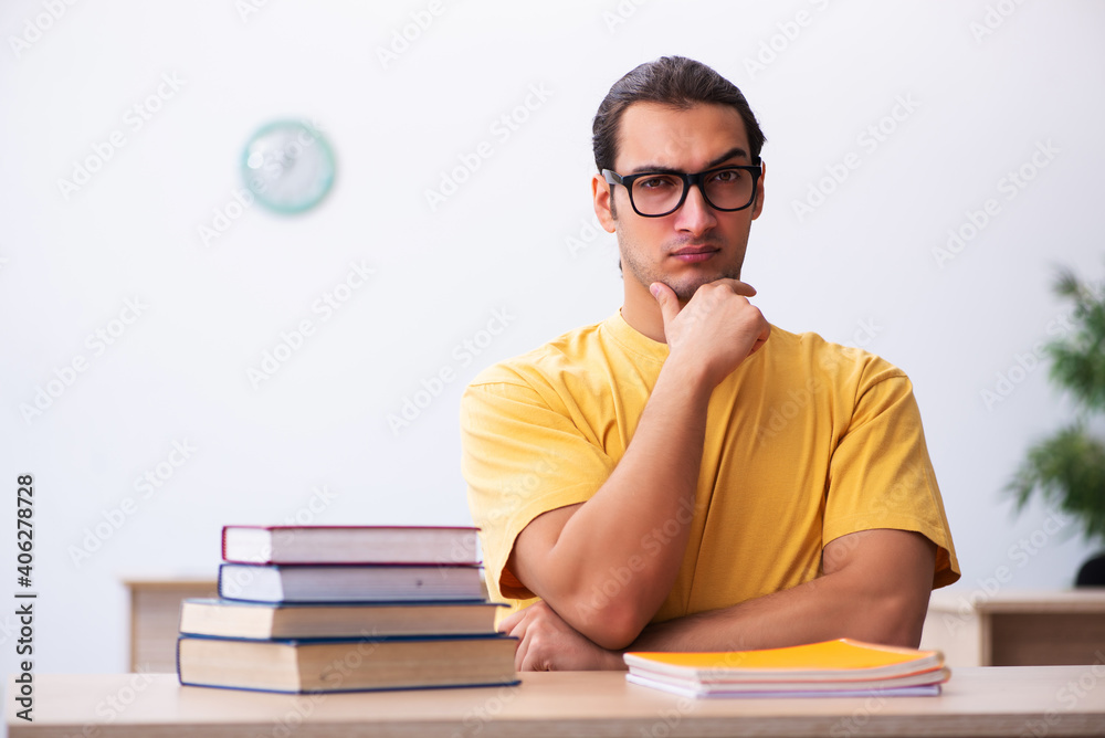 Young male student preparing for exams in the classroom Young male student preparing for exams in the classroom