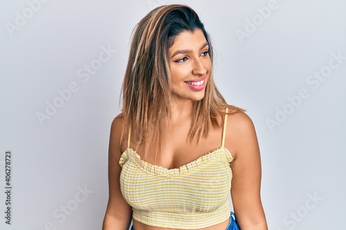 Obraz na plátně Beautiful brunette woman wearing casual clothes looking to side, relax profile pose with natural face and confident smile