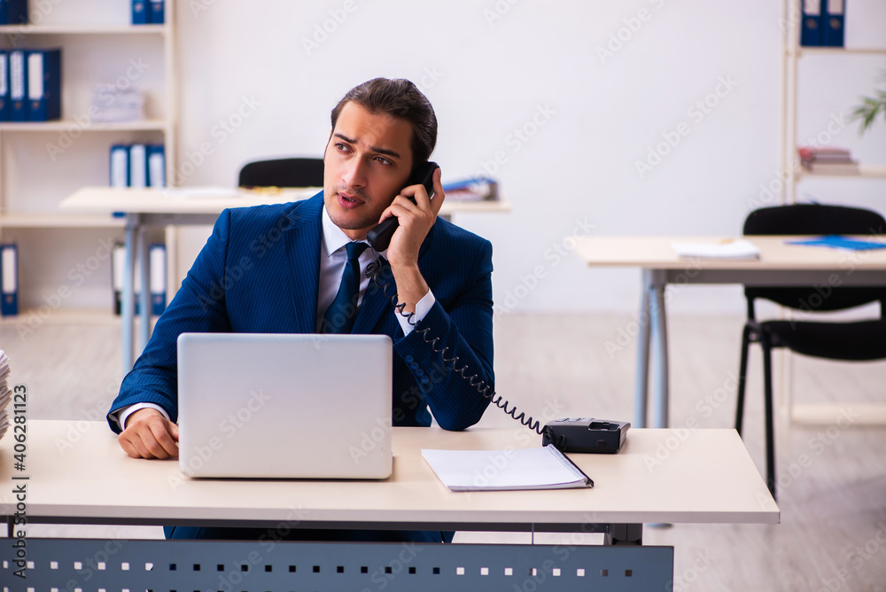 Young male employee working in the office Young male employee working in the office