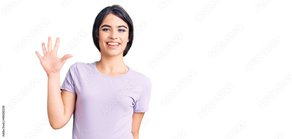 Brunette teenager girl wearing casual clothes showing and pointing up with fingers number five while smiling confident and happy. Brunette teenager girl wearing casual clothes showing and pointing up with fingers number five while smiling confident and happy.