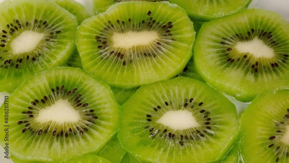Milk fills fresh kiwi slices. Close up, top view. 4k, slow motion. Milk fills fresh kiwi slices. Close up, top view. 4k, slow motion.