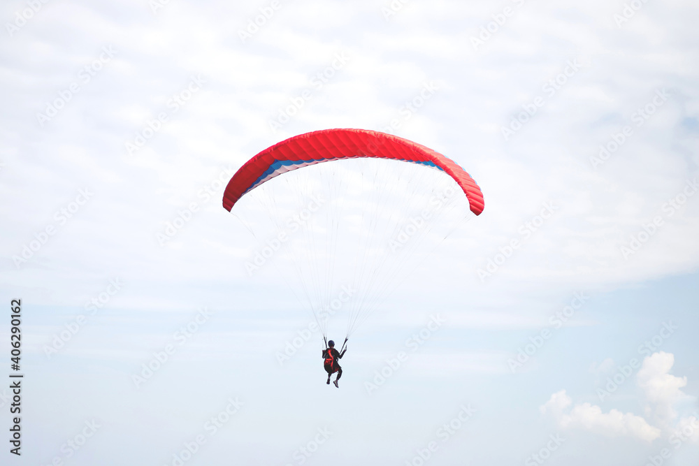 Red parachute landing on windy day.. Red parachute landing on windy day..