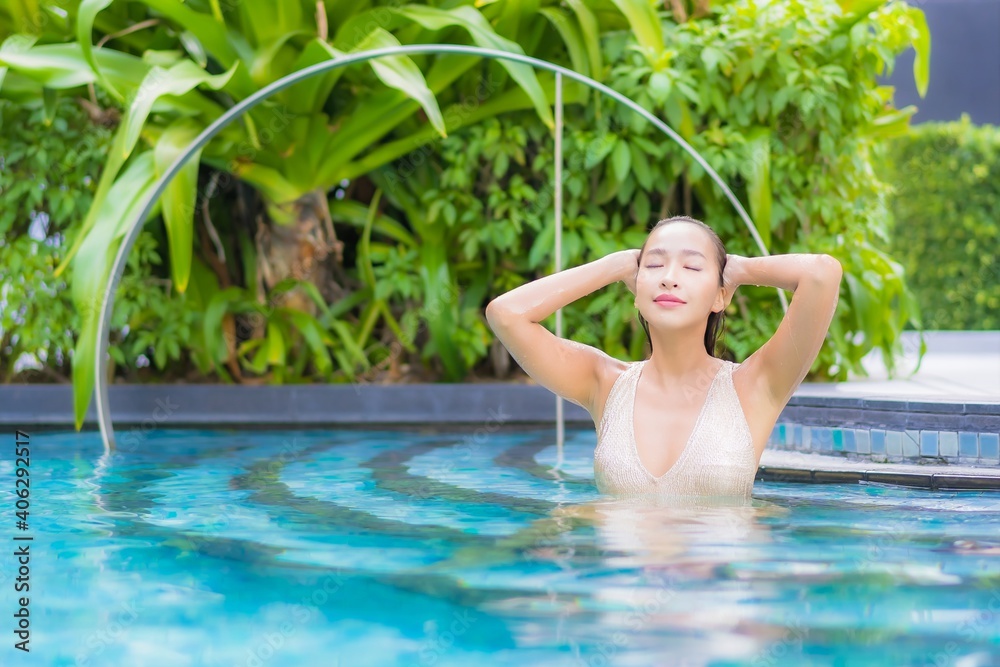 Portrait beautiful young asian woman relax smile leisure on vacation around swimming pool