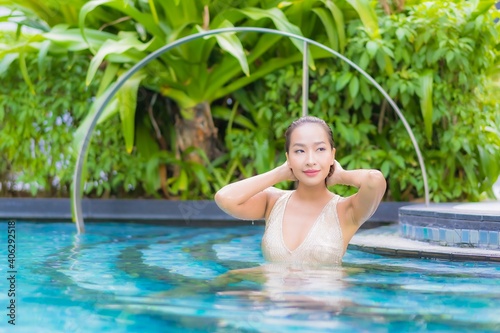 Portrait beautiful young asian woman relax smile leisure on vacation around swimming pool © siraphol