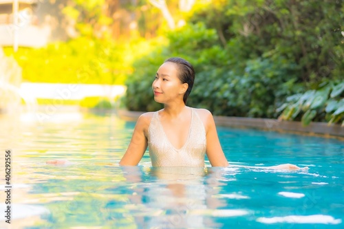 Portrait beautiful young asian woman relax smile leisure on vacation around swimming pool