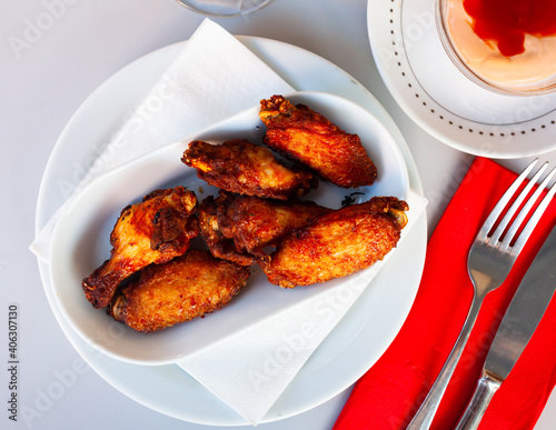 cooked and served on white plate chicken wings for dinner photo