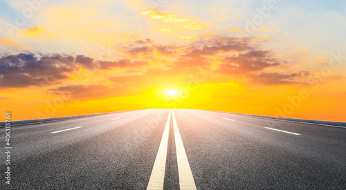 Asphalt road and sky clouds at sunset.Road background. © ABCDstock