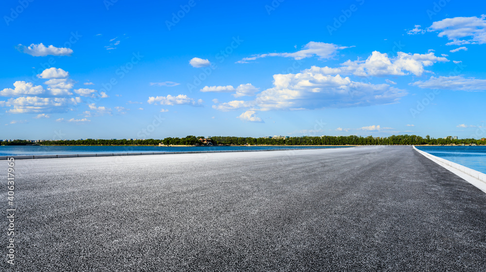 Empty asphalt road and blue sky with white clouds.
