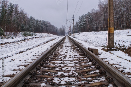 railway tracks passing through the winter forest