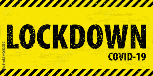Black and yellow warning  grunge tape  with text LOCKDOWN COVID-19. Blocked access sign based on coronavirus disease. EPS10. 