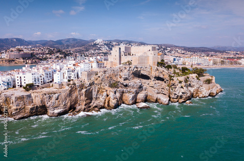 Picturesque aerial view of medieval Peniscola Castle on rocky hilltop on Mediterranean coast, Spain
