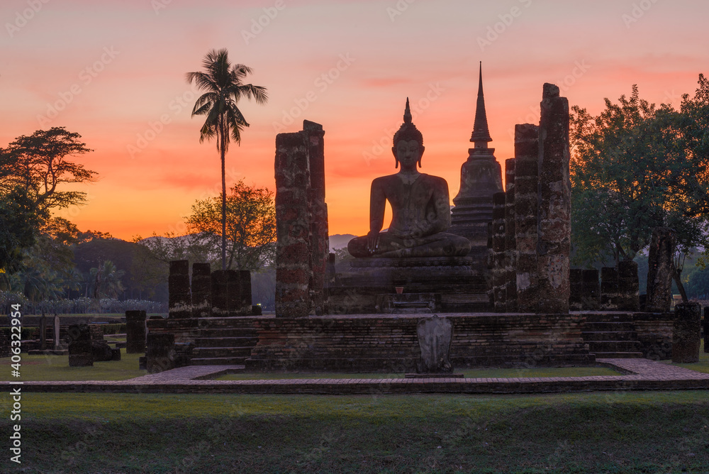 Ruins of the ancient Buddhist temple Wat Chana Songkhram against the backdrop of a bright sunset. Sukhothai, Thailand