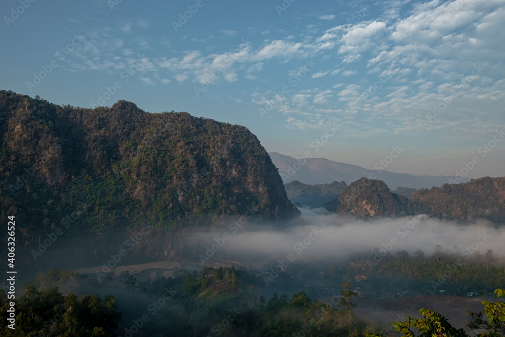 Mountain views and mist flowing through the gorge, clear sky. Mea Usu Cave, Tak in Thailand. Mountain views and mist flowing through the gorge, clear sky. Mea Usu Cave, Tak in Thailand.
