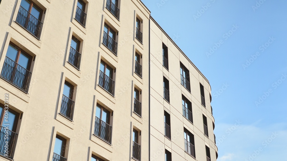 Fragment of modern luxury residential apartment, home house building concept. Modern apartment building on a sunny day with a blue sky. Fragment of modern luxury residential apartment, home house building concept. Modern apartment building on a sunny day with a blue sky.