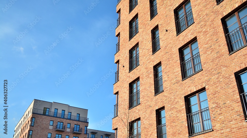 Colorful modern residential building. New luxury house and home complex of red color. City Real estate property and condo architecture. Colorful modern residential building. New luxury house and home complex of red color. City Real estate property and condo architecture.