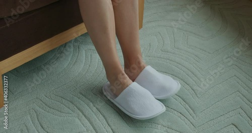 Woman wear slipper at hotel room
