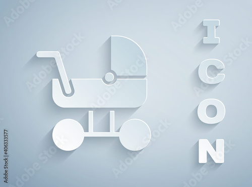 Paper cut Baby stroller icon isolated on grey background. Baby carriage, buggy, pram, stroller, wheel. Paper art style. Vector.