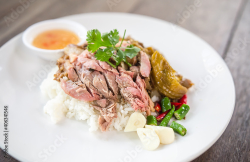 Pork leg rice on a wooden table, soft focus image.