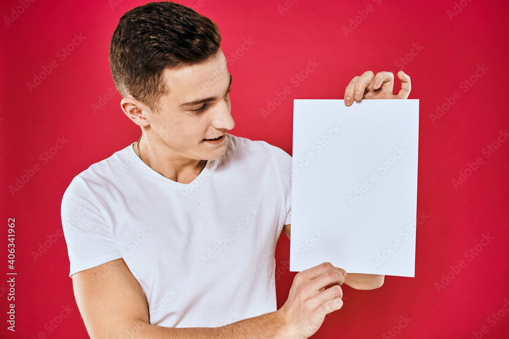 man holding white sheet copy space office close-up red background man holding white sheet copy space office close-up red background