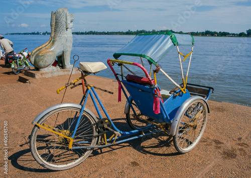 Cyclo Khmer at riverside waiting passenger