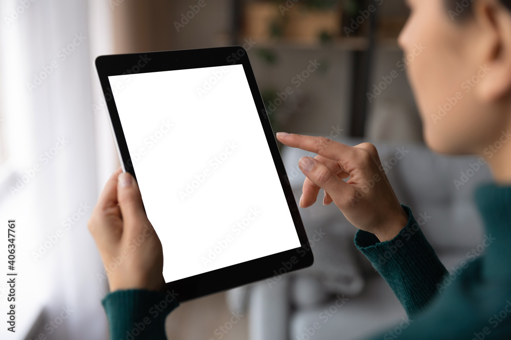 Close up back view of woman use tablet browse wireless internet on gadget. Millennial female user hold pad device text or message online. Mockup screen, technology, communication concept.