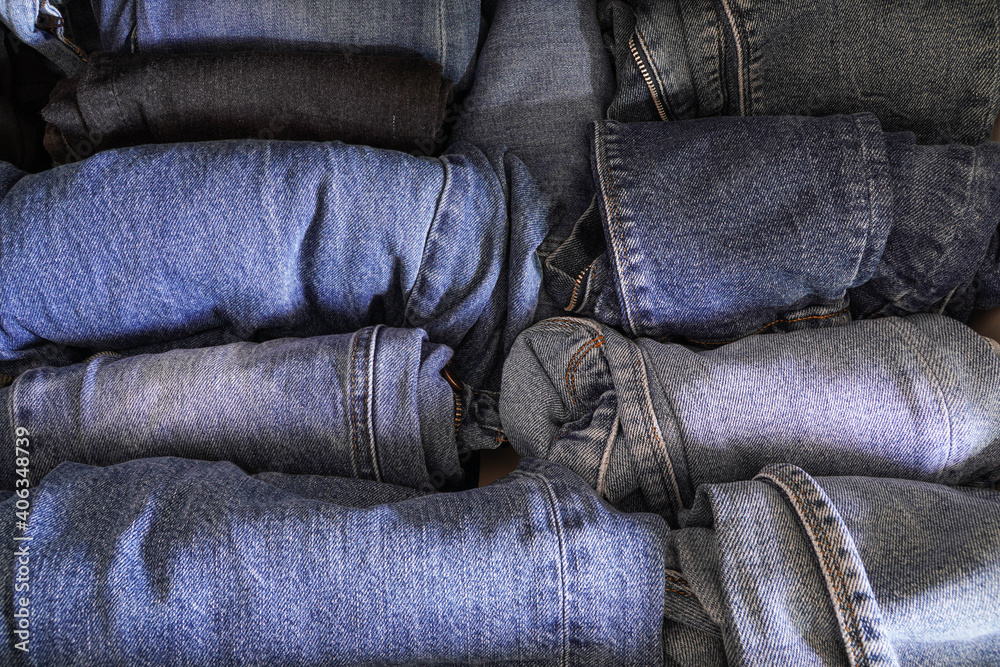 Blue Jeans Pants Clothing Stack background Stacked blue jeans in the closet
