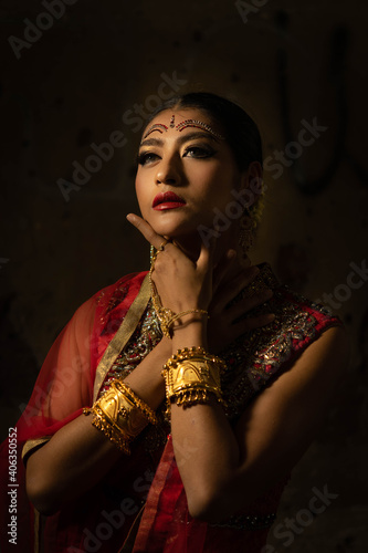 Portrait of beautiful indian girl with kundan jewelry set. Traditional India costume lehenga choli or sari