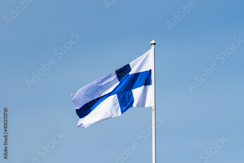 Finnish national flag on the wind against the blue sky