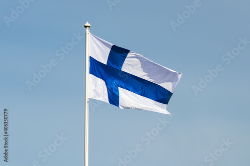 Finnish national flag on the wind against the blue sky