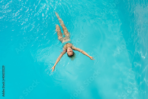 Beautiful women relaxing at the luxury poolside. Female at travel spa resort pool. Summer luxury vacation.