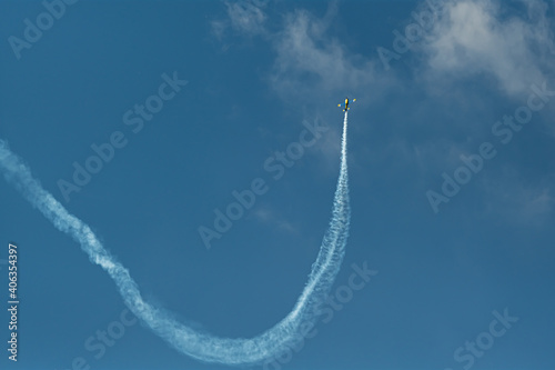 The aerobatic plane with smoke track in the sky photo