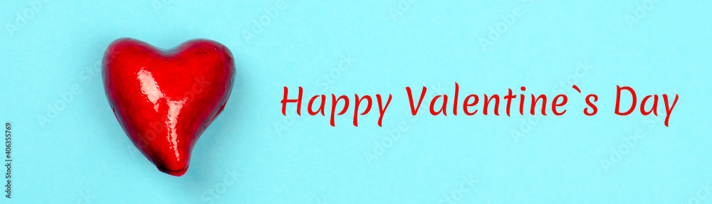 Small red heart on a blue background. Words Happy Valentine's Day banner