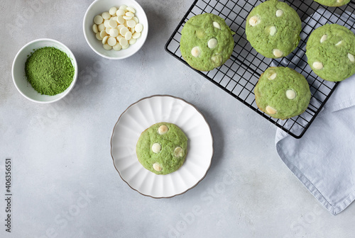 Homemade matcha and chocolate chip cookies on cooling rack. Healthy nutrition. gray background. flat lay. space for text