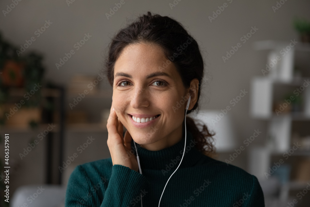 Headshot portrait of smiling young Caucasian woman in headphones enjoy good quality sound relaxing. Profile picture of happy millennial female listen to music in modern earphones. Technology concept. Headshot portrait of smiling young Caucasian woman in headphones enjoy good quality sound relaxing. Profile picture of happy millennial female listen to music in modern earphones. Technology concept.