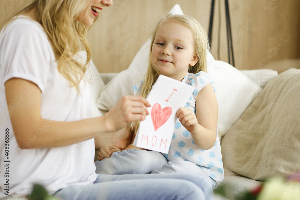 Happy mother day. Child daughter congratulates mom and gives her postcard with heart drawing. Family and childhood concepts Happy mother day. Child daughter congratulates mom and gives her postcard with heart drawing. Family and childhood concepts
