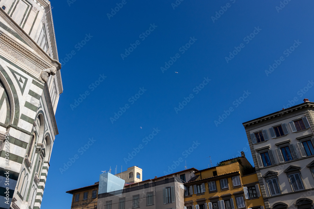 plane and moon in the sky over florence. the sky over the Baptistery of San Giovanni