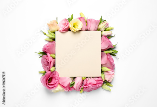 Fototapeta Naklejka Na Ścianę i Meble -  Beautiful Eustoma flowers and blank card on white background, flat lay. Space for text